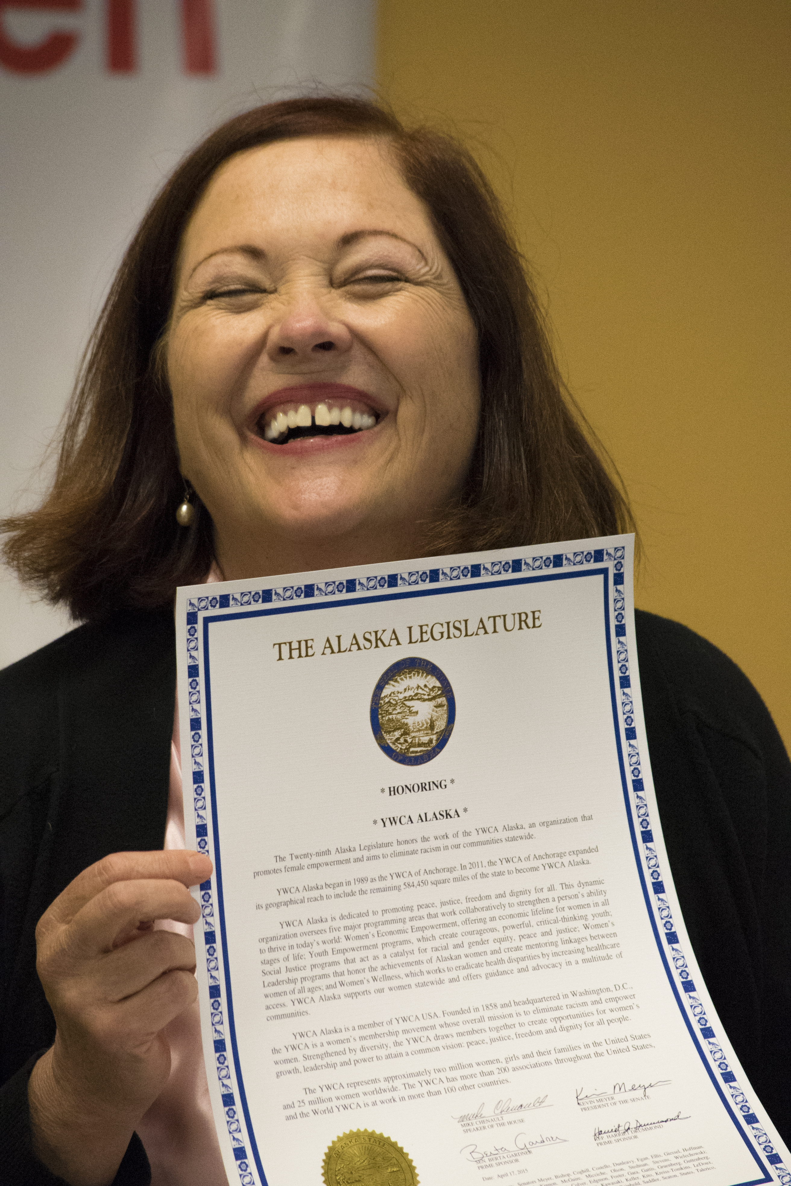 Senator Berta Gardner presenting YWCA Alaska with a Legislative Citation recognizing our work
